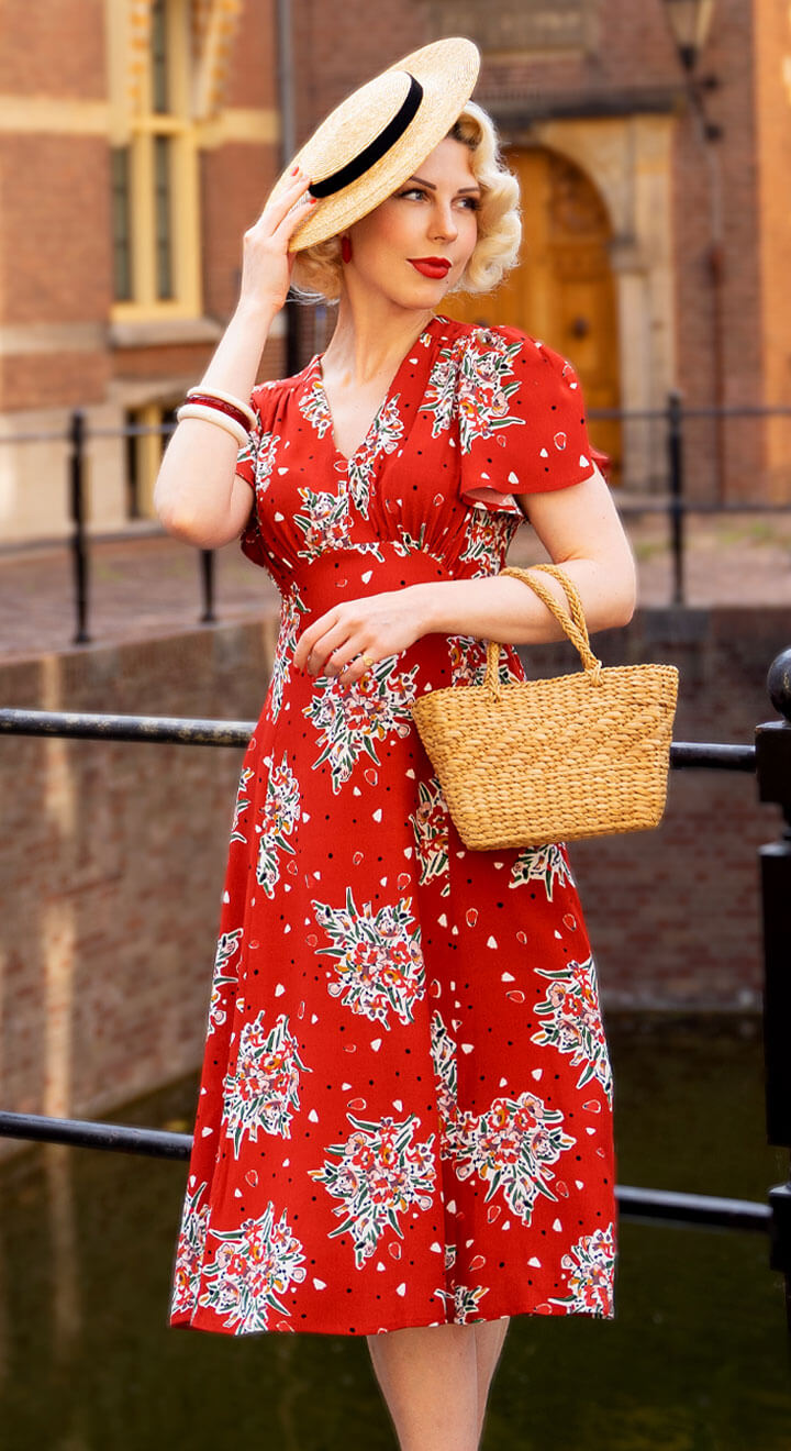 https://www.weekenddoll.co.uk/cdn/shop/products/1930s-Style-Betty-Tea-Dress-in-Red-Floral-Model-Weekend-Doll--W_720x.jpg?v=1680627834